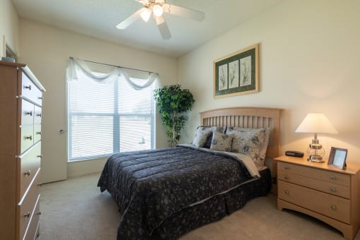 A comfortable sleeping space with soft lighting and plush carpeting.